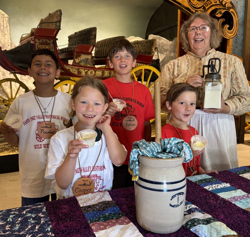 4 kids learning how to make churn butter at Wild West Camp 2024