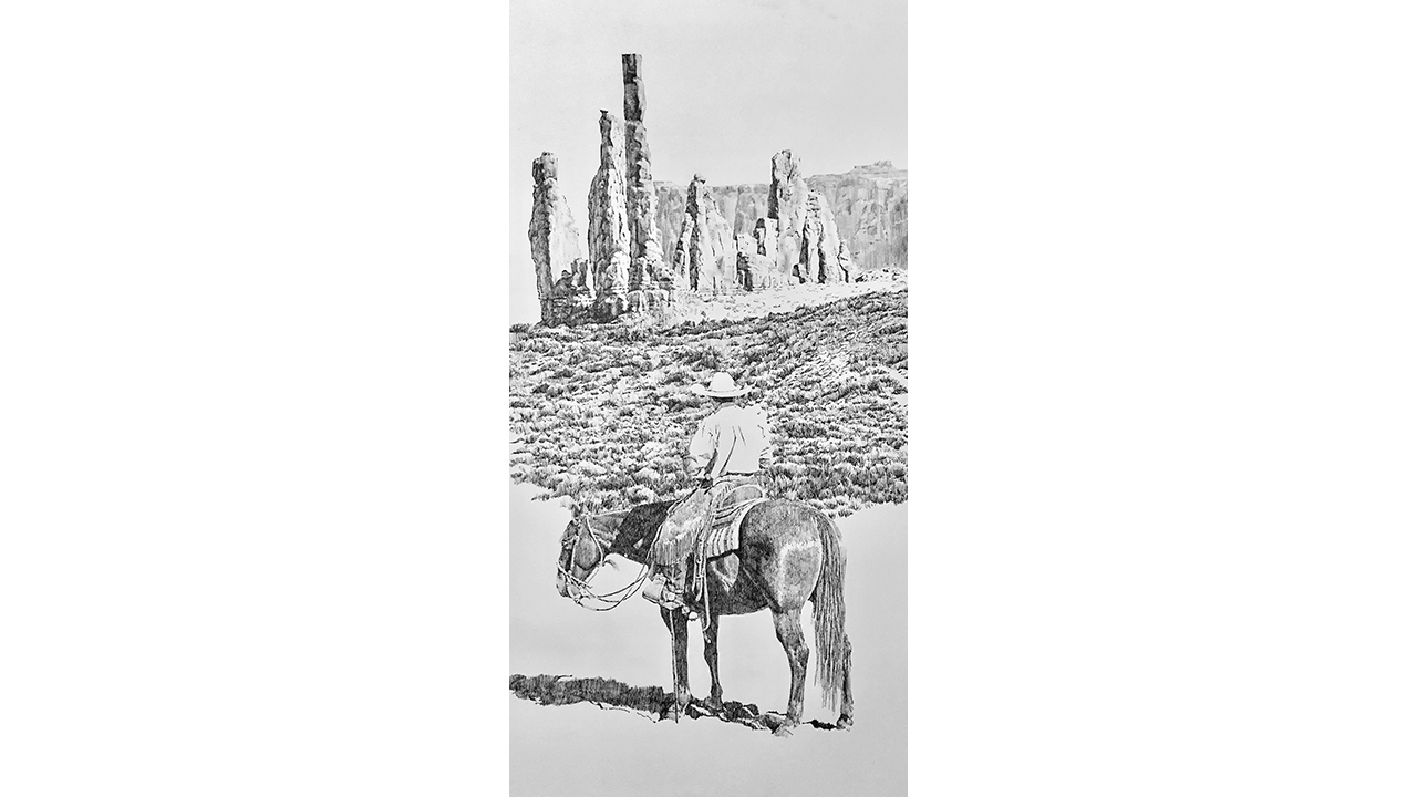 man on horseback looking away into desert landscape