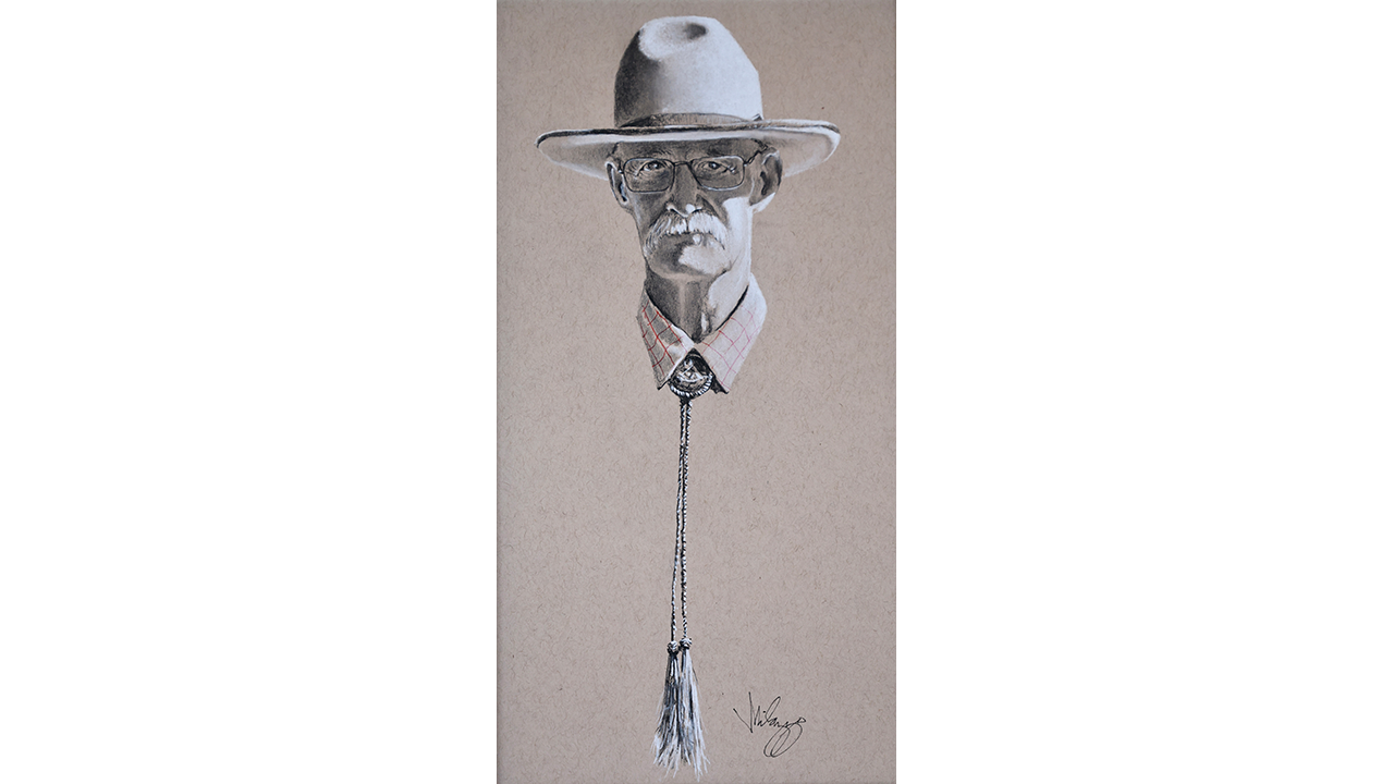 portrait of bearded gentleman in hat and glasses, long braided bolo tie
