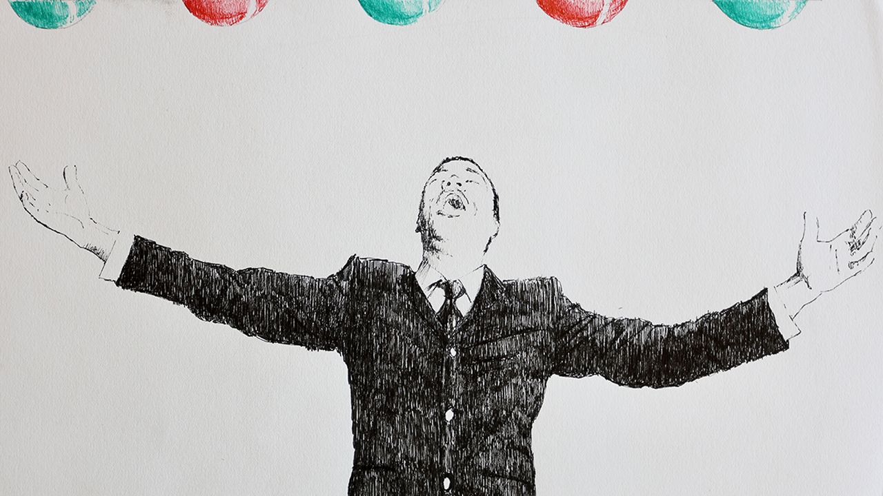 man singing with arms outstretched, hints of Christmas bulbs overhead