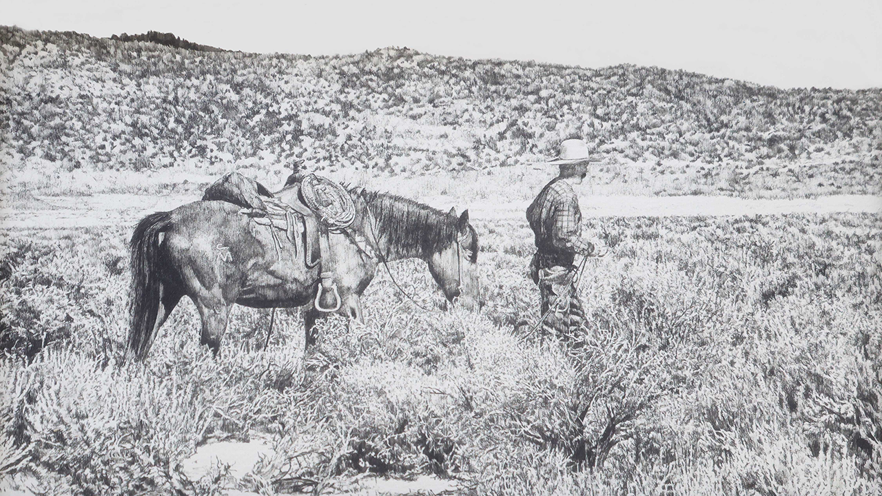 cowboy walking with horse through desert landscape