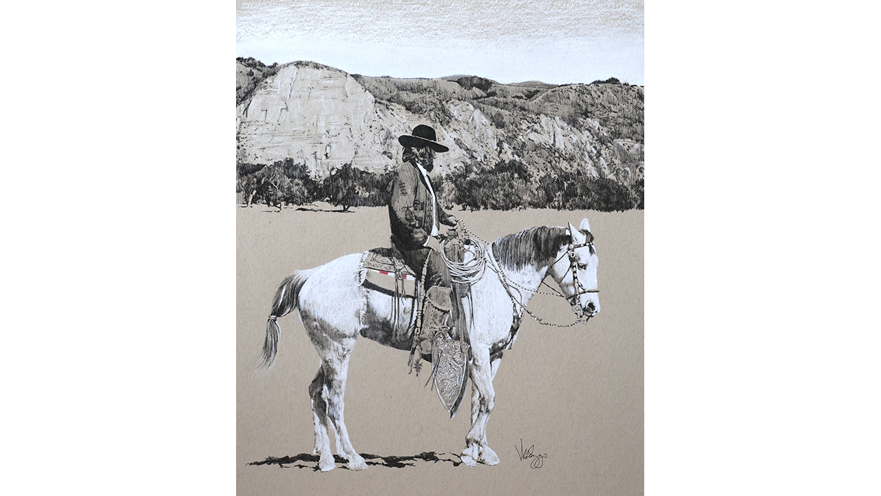 vaquero on white horse with mountains in background
