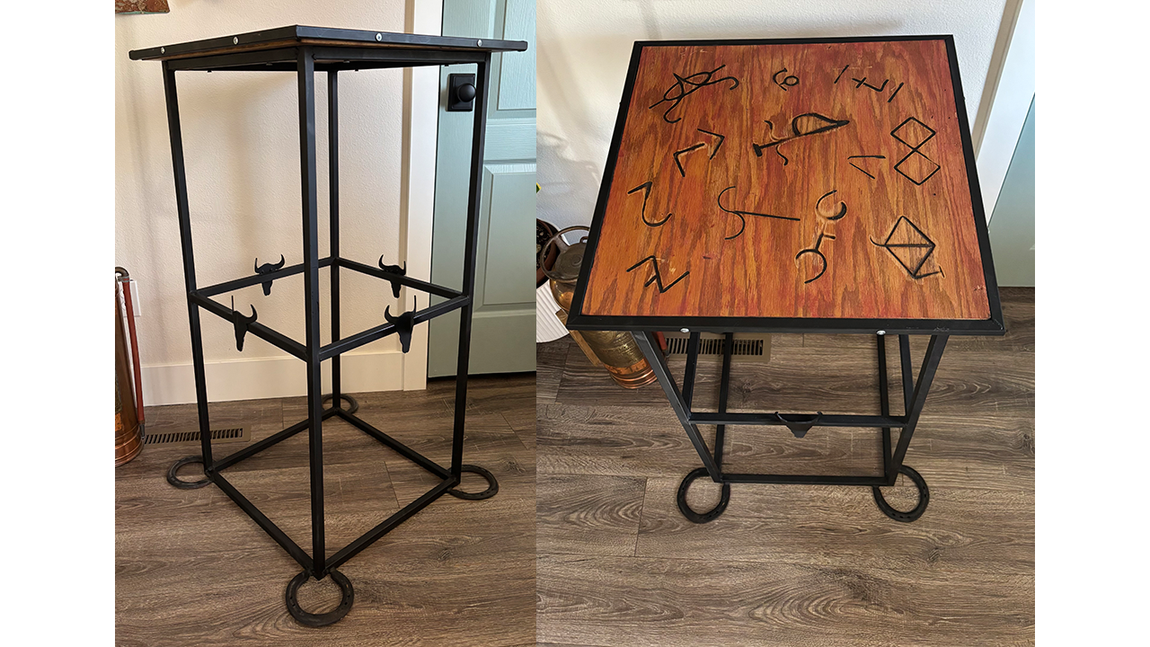 metal end table with wooden top, decorated with different cattle brands