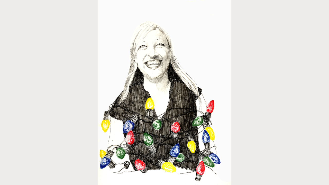 Laughing woman wrapped up n Christmas light bulbs
